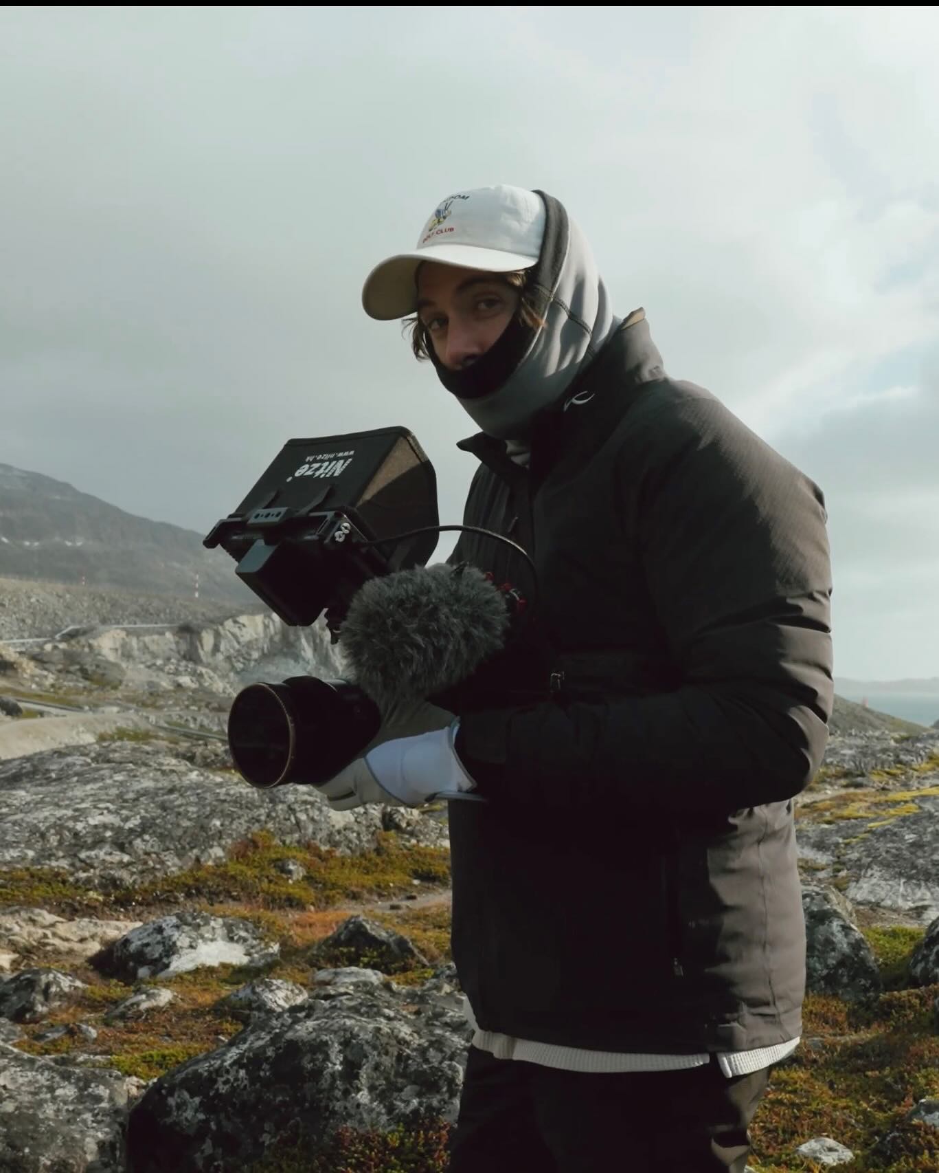 Keffer Rhodes operating a camera rig on the rocky coast of Greenland